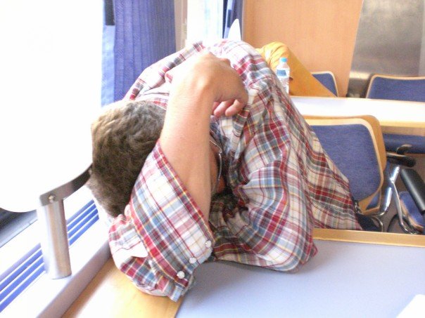 a guy hungover on a train