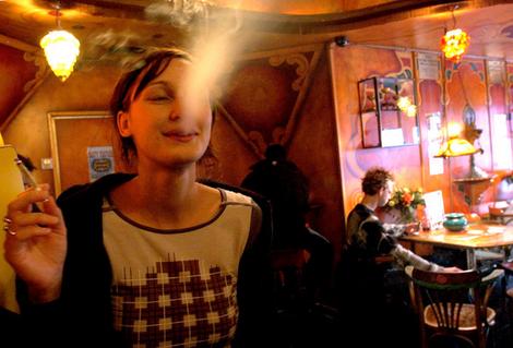 dutch girl smoking a joint in a cafe in Amsterdam