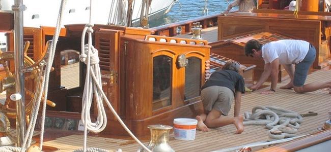 Crew members cleaning the yacht