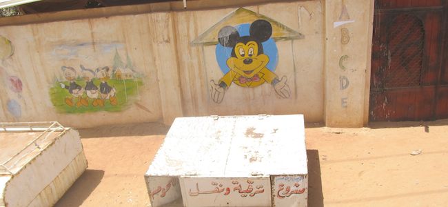 a sudanese elementary school with mickey mouse painted on the out side