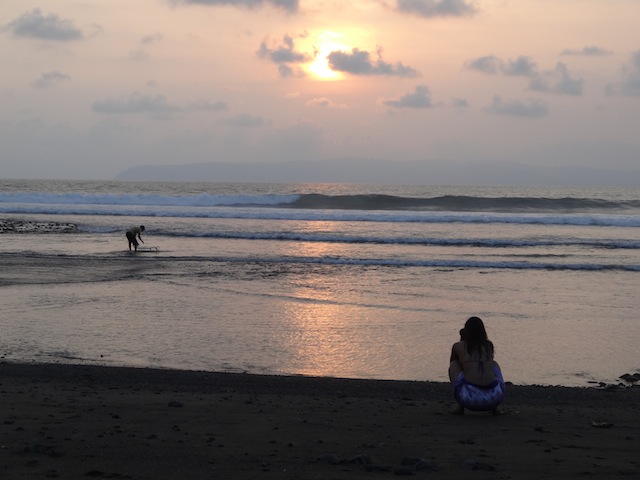 surfer going out at sunset in Pavones Costa Rica