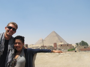 standing on a roof looking at the great pyramids