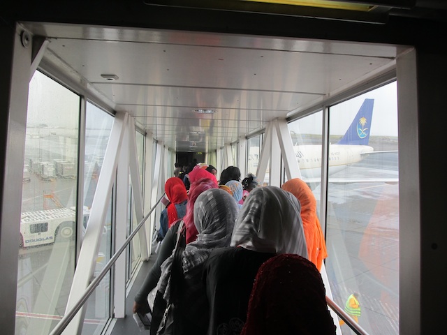 Ethiopian women boarding a flight to Saudi Arabia to become underpaid servants.